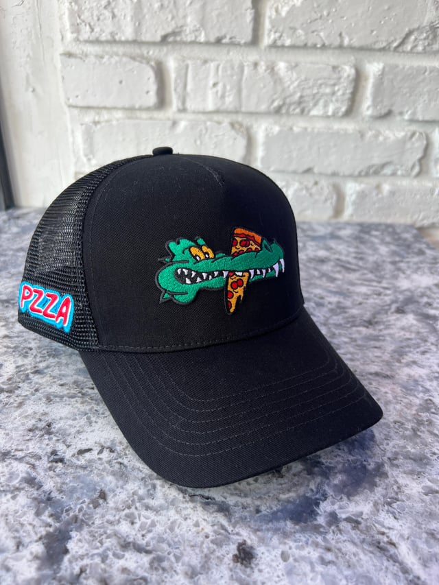Black PZZA& trucker hat with embroidered green gator biting a pizza slice